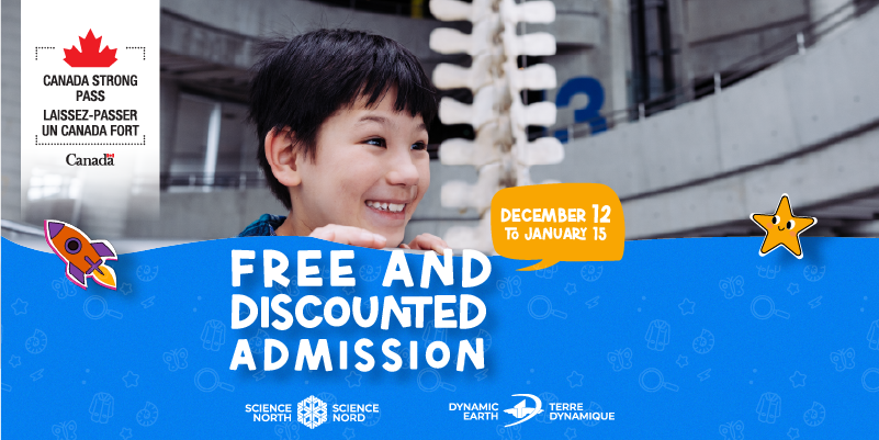 young boy peeking over the science north ramp with fine whale skeleton in background