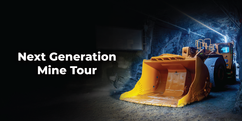 Underground mine setting with a large yellow front‑end loader parked on a dirt tunnel floor. Rock walls surround the machine, lit by cool overhead lighting. Text reads “Next Generation Mine Tour.”
