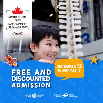 picture of a young boy overlooking the science north ramp with a fin whale skeleton behind him in the background
