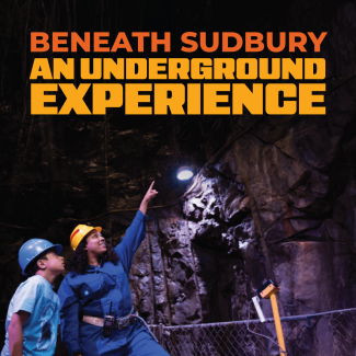 Promotional image reading “Beneath Sudbury: An Underground Experience” in bold orange text. Two visitors wearing hard hats stand in a rocky underground mine, with one pointing toward the illuminated rock ceiling.